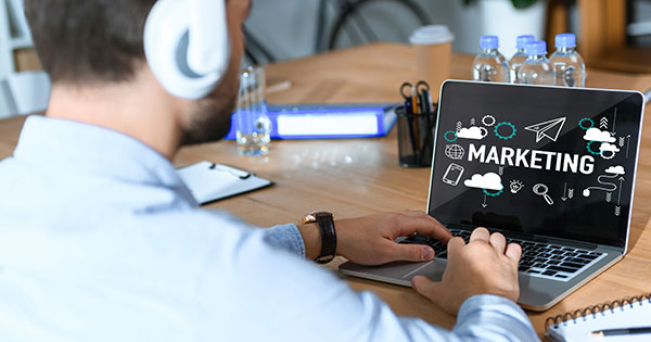 Stock photo of person on their laptop doing online marketing